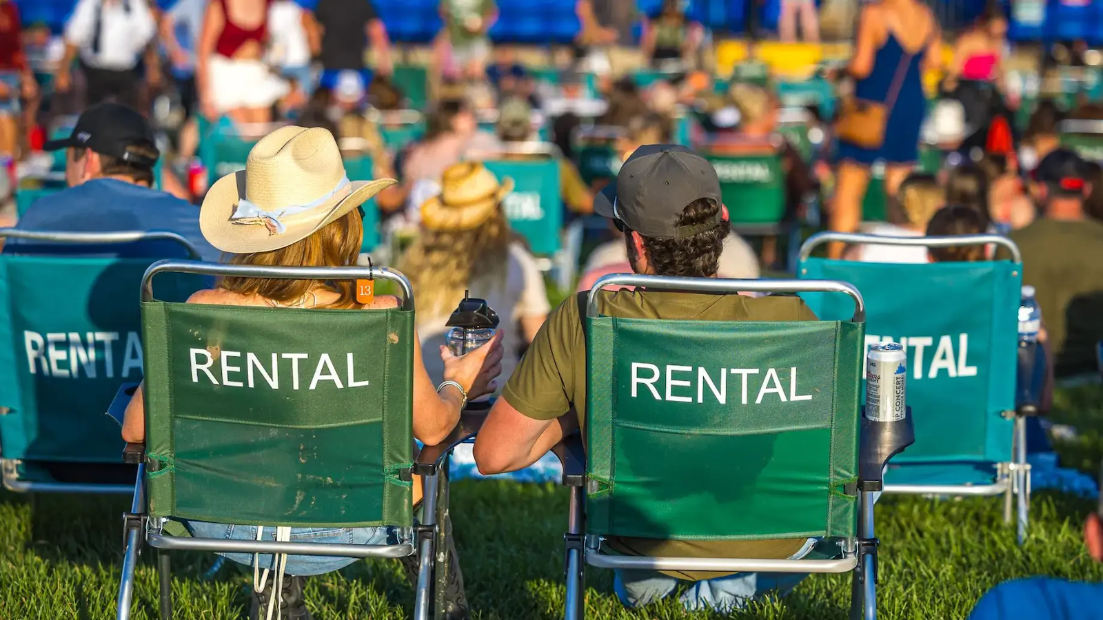 Attendees sitting on rental chairs in the lawn at the amphitheater