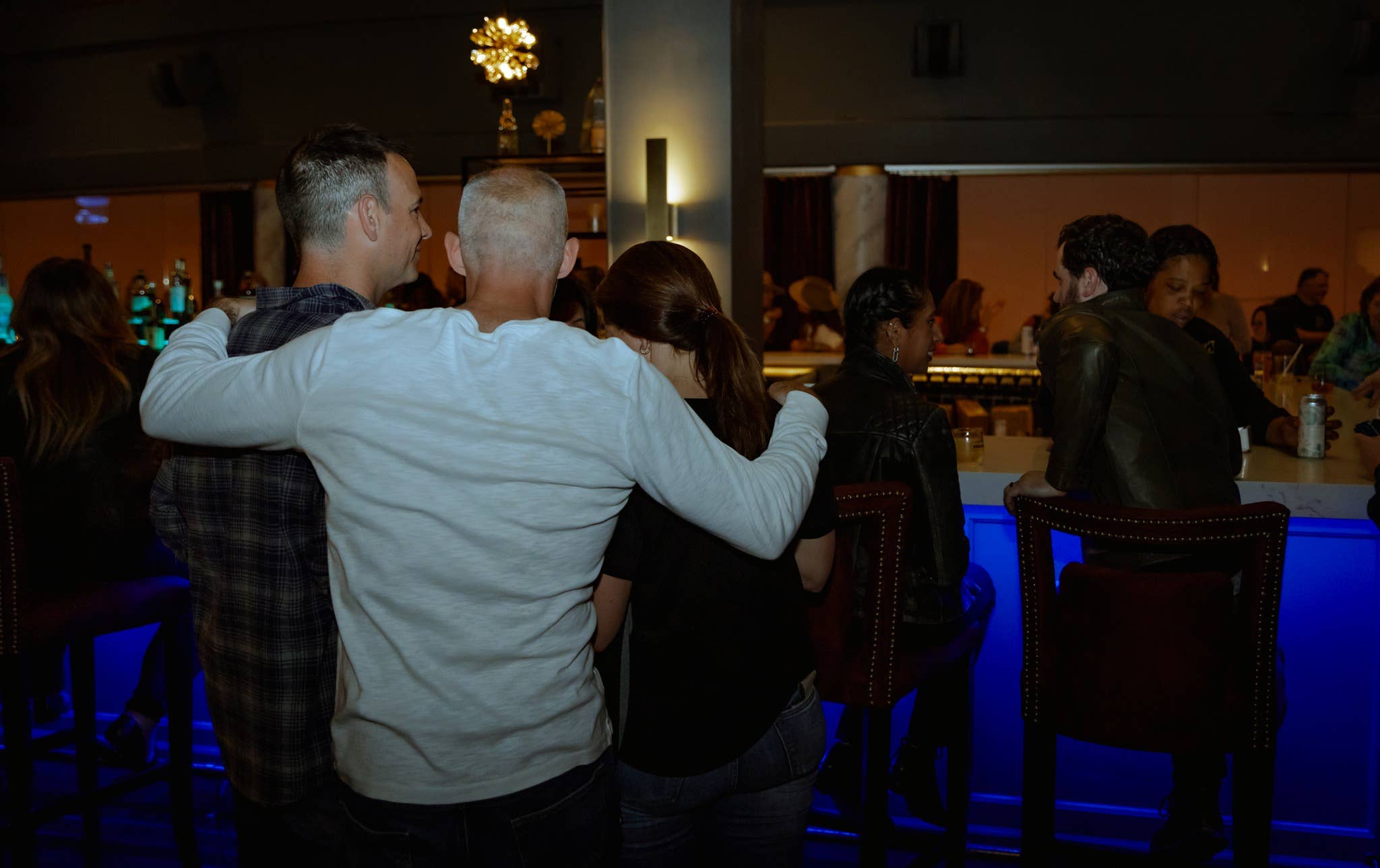 The back of people hanging out in the lobby