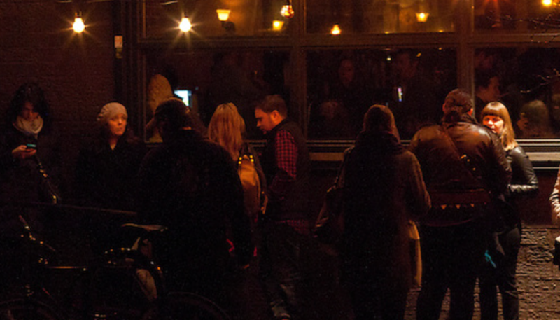 An exterior shot of the crowd queuing up to check in before a show.