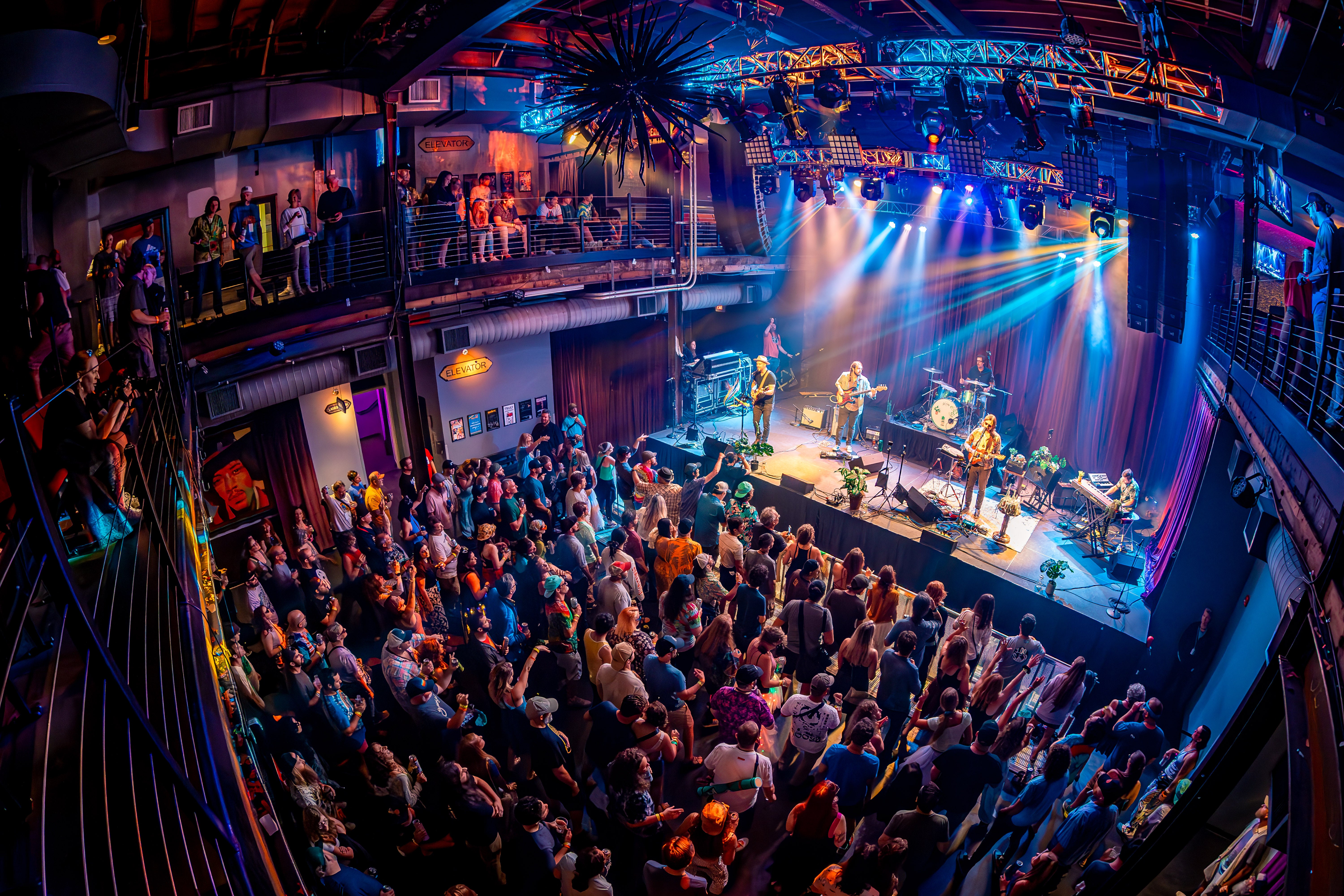Upstairs at Mercury Ballroom with crowd and band in view. 