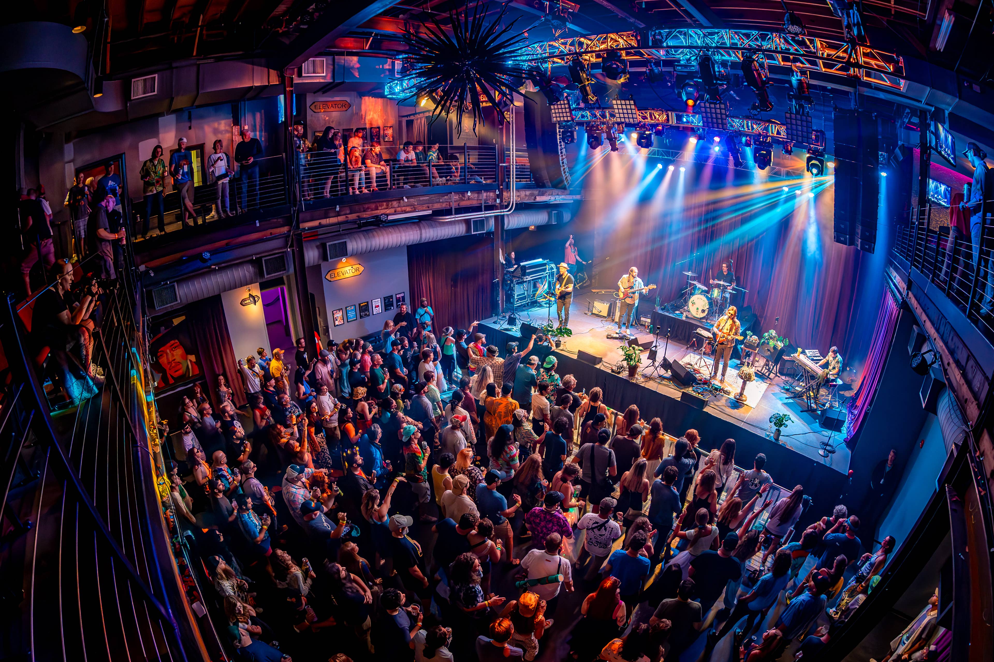 Upstairs at Mercury Ballroom with crowd and band in view. 