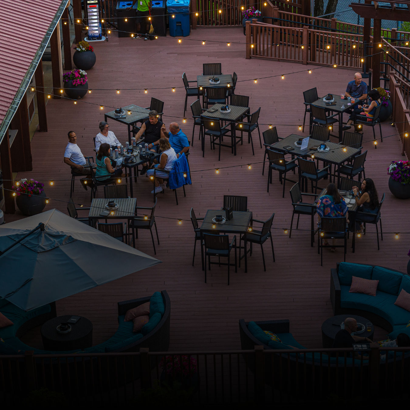 People sitting at tables while eating and drinking in the VIP Club at Credit Union 1 Amphitheatre.