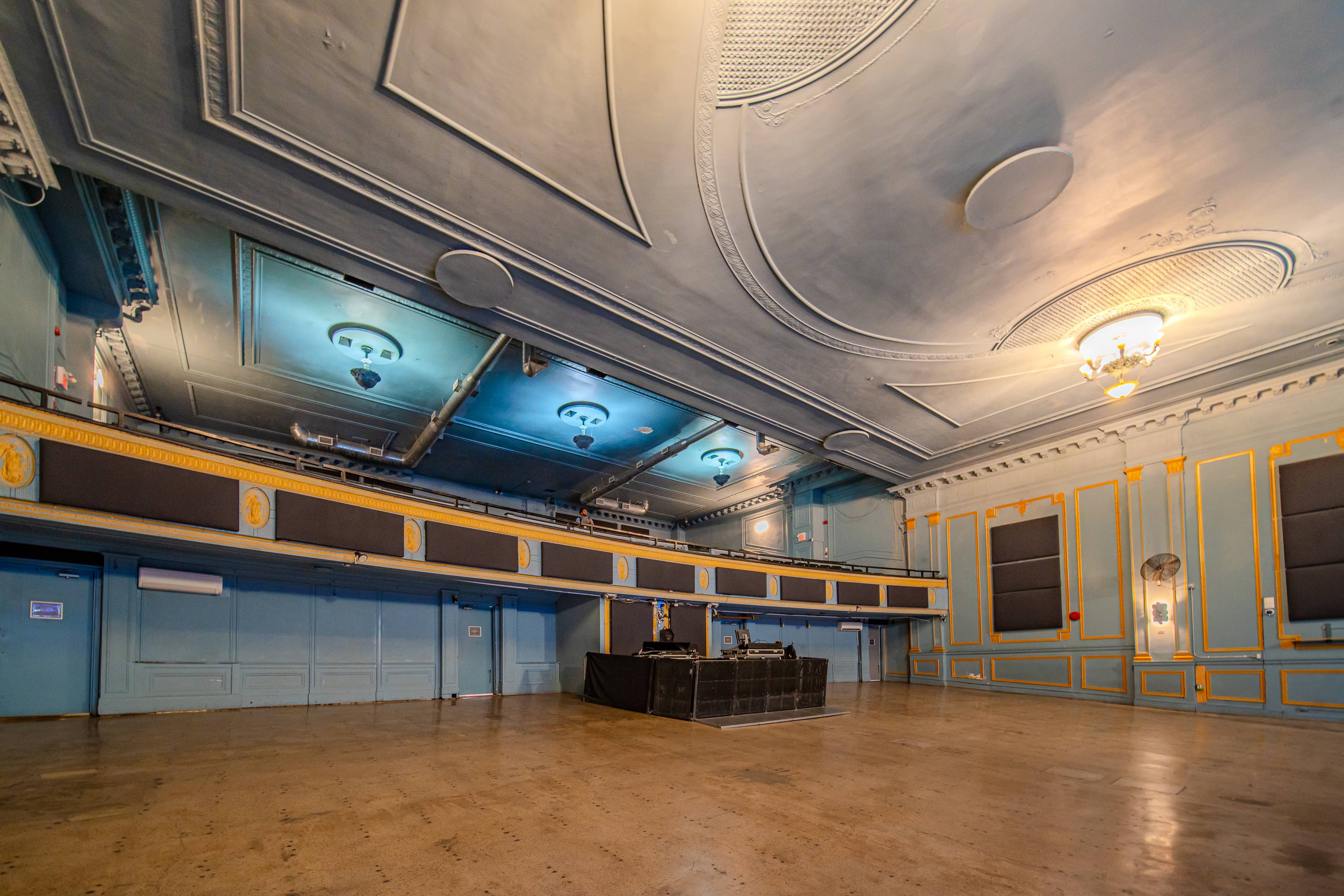 view of the empty floor at the danforth music hall in toronto from the side of the room