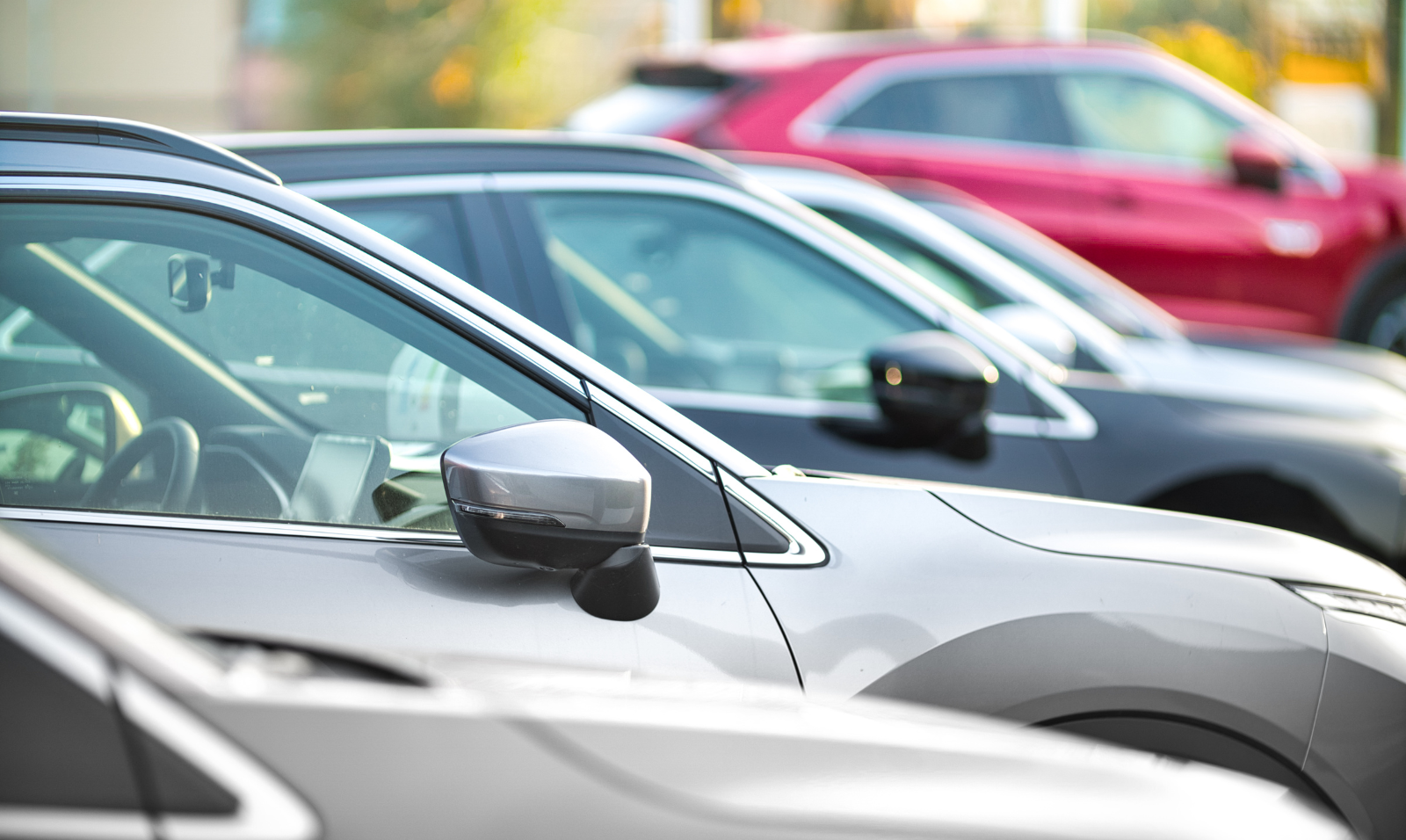 Cars are seen lined up in a parking lot.