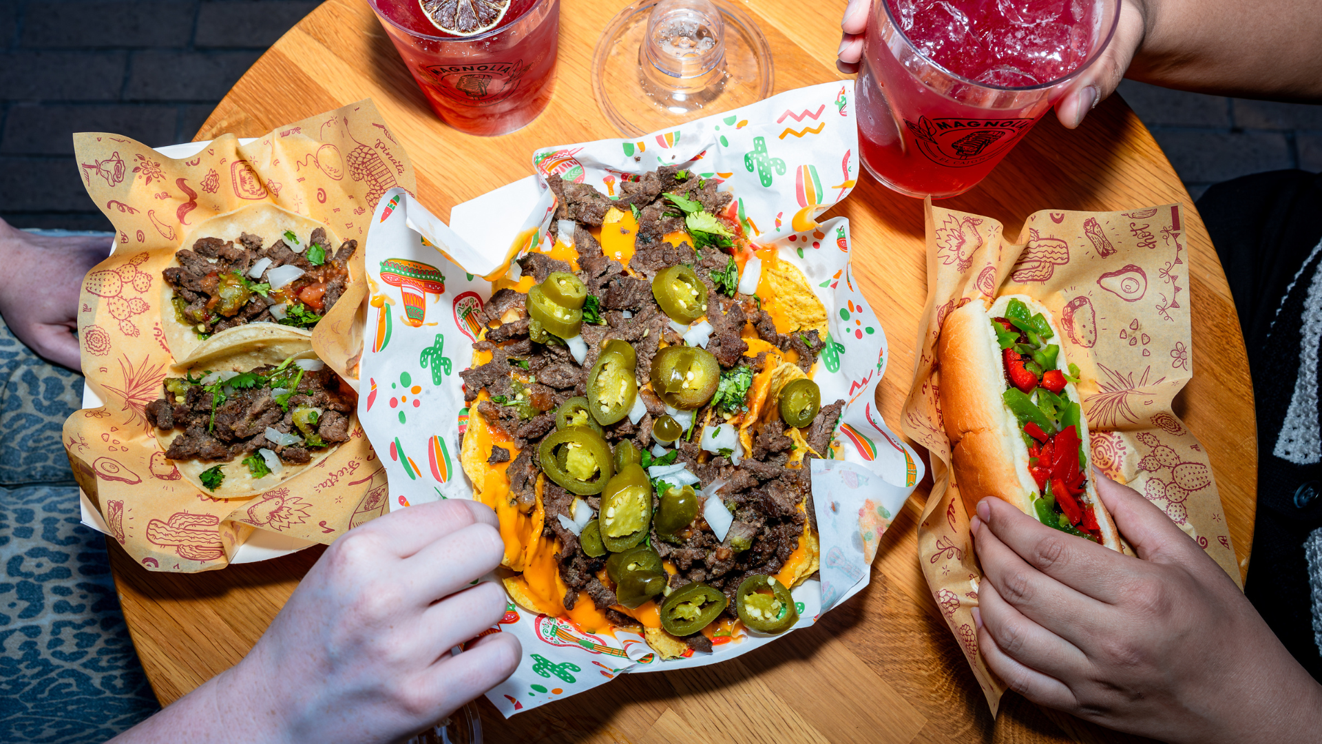 picture of our food: nachos, tacos, and a hot dog