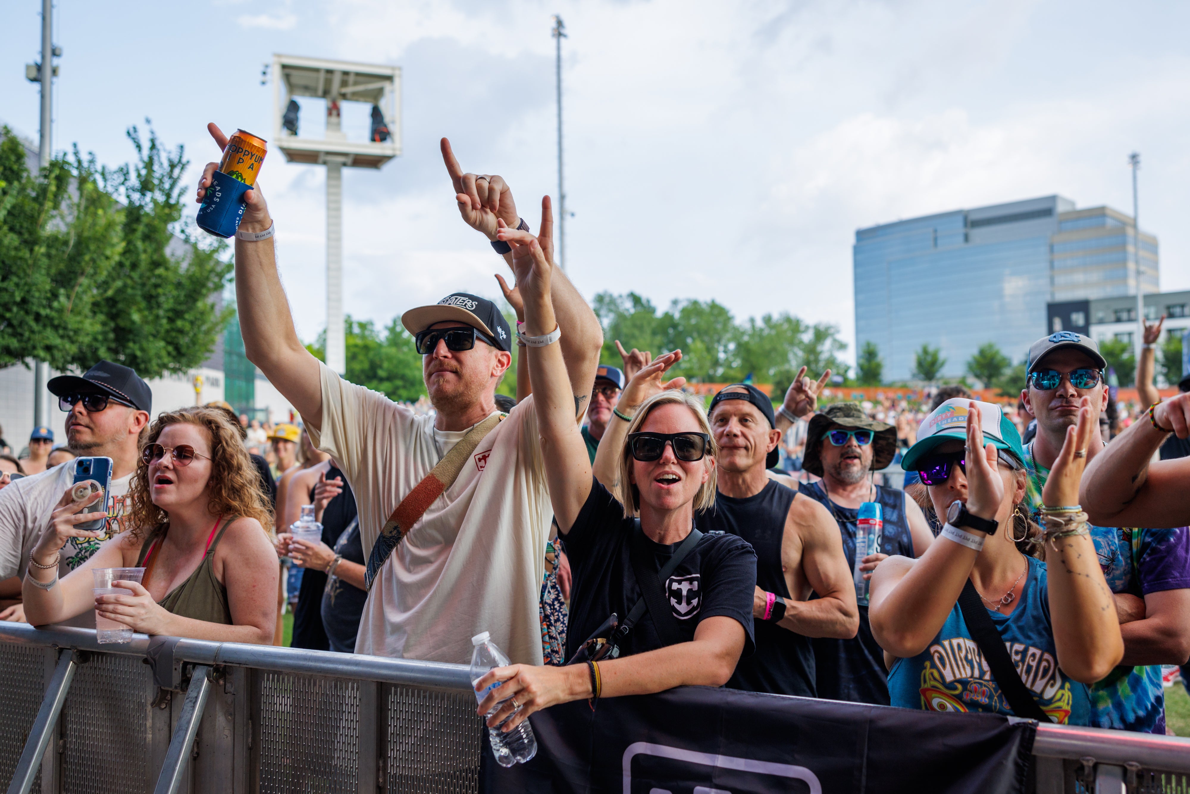 Fans in front of the stage with their hands up.