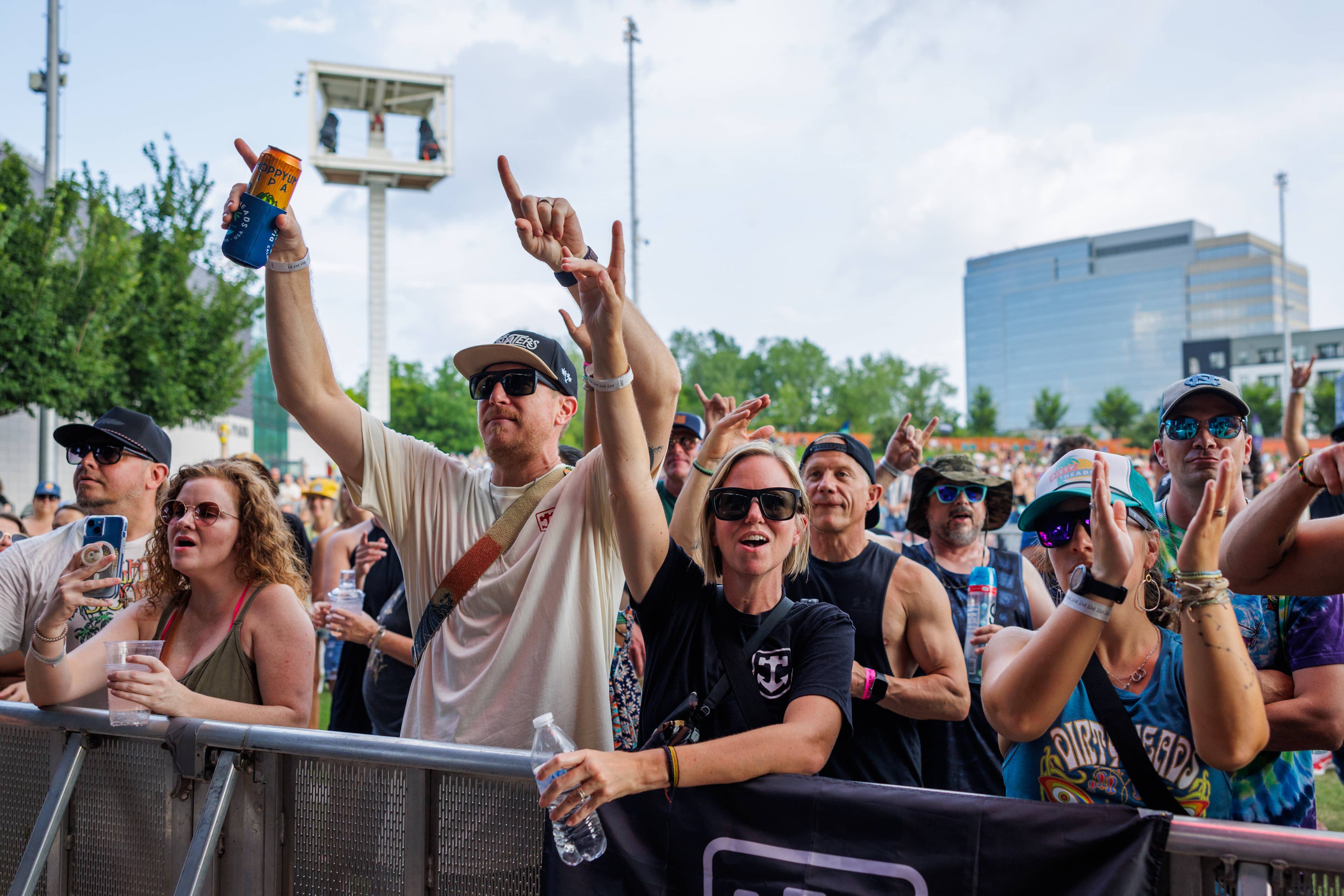 Fans in front of the stage with their hands up.