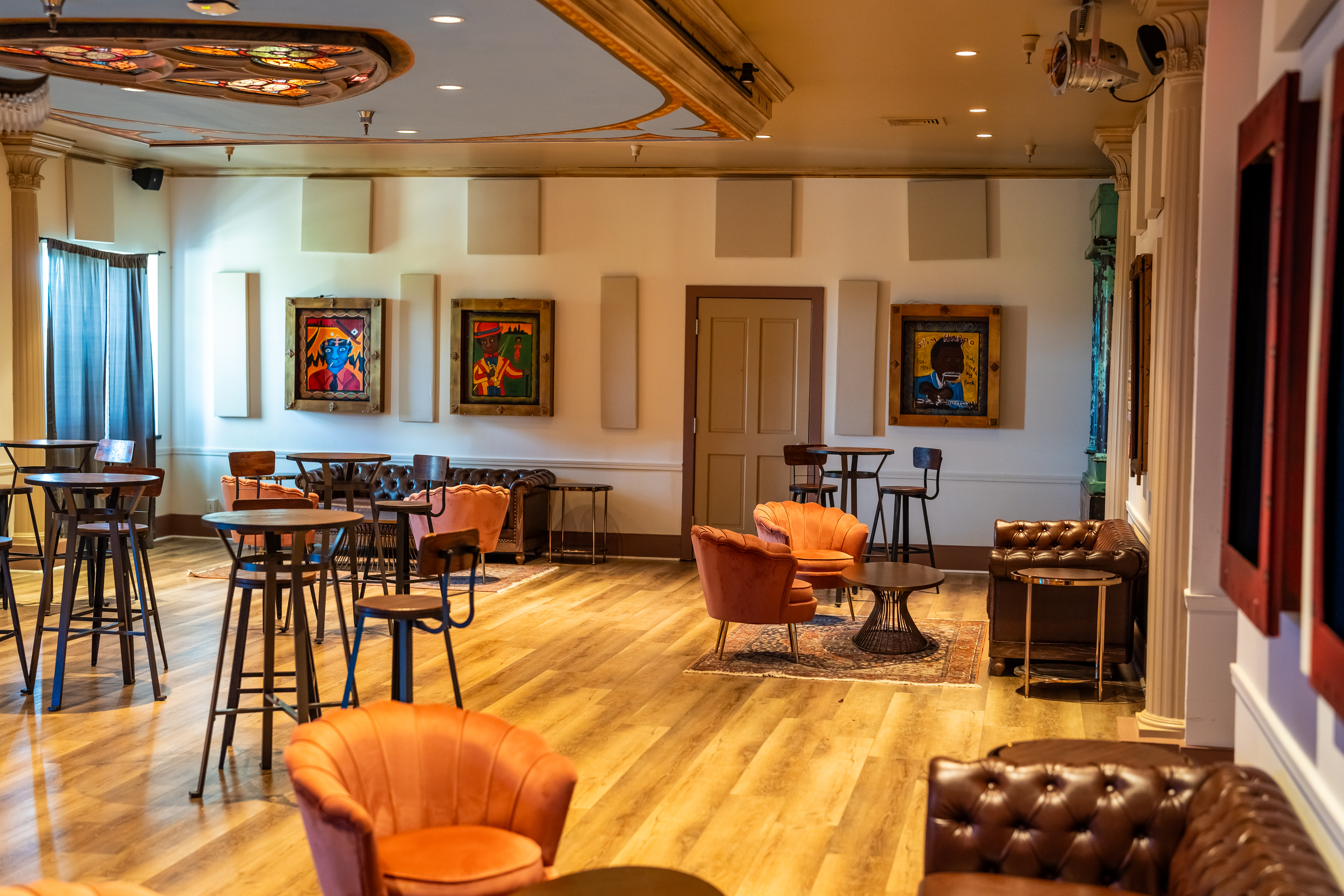 A room with chairs and tables set up lounge style for VIP gatherings. 