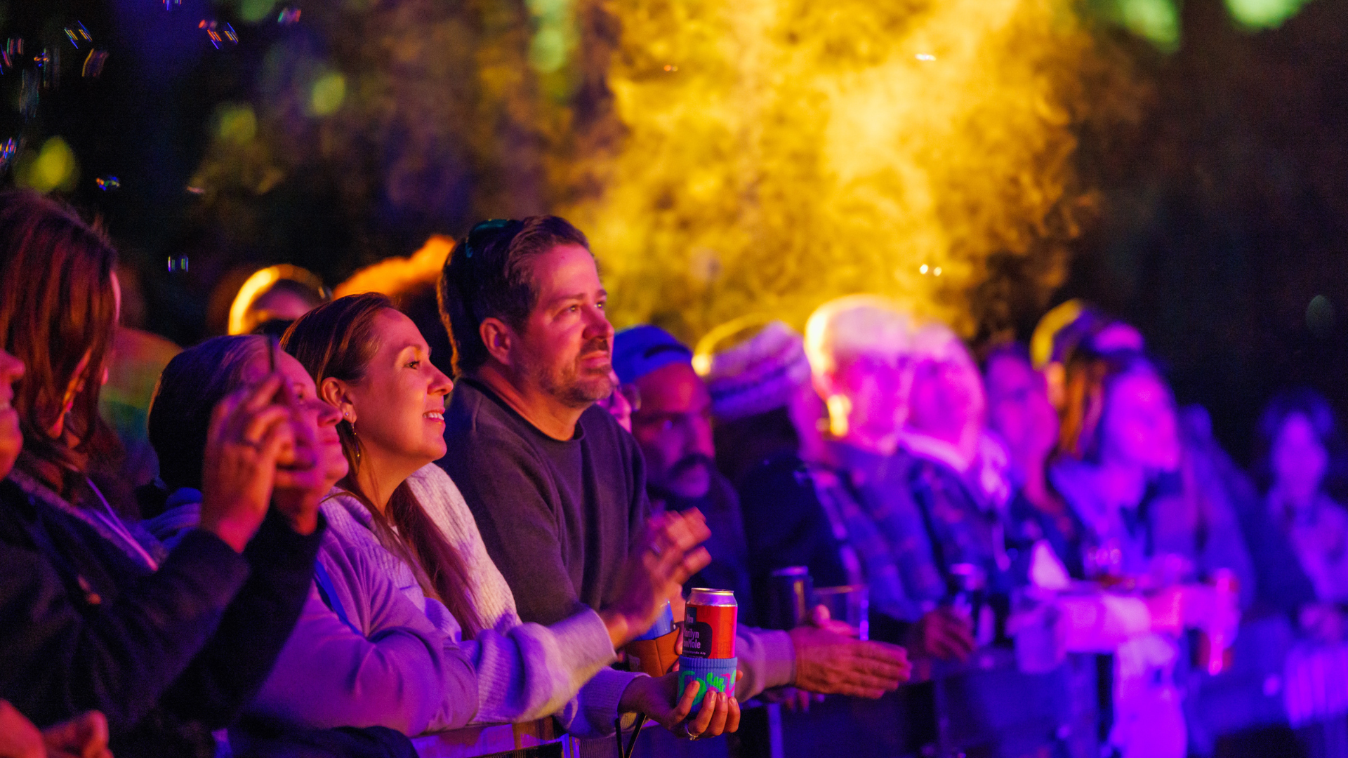 An image of a man and woman in front of the stage at Greenfield Lake enjoying the show.