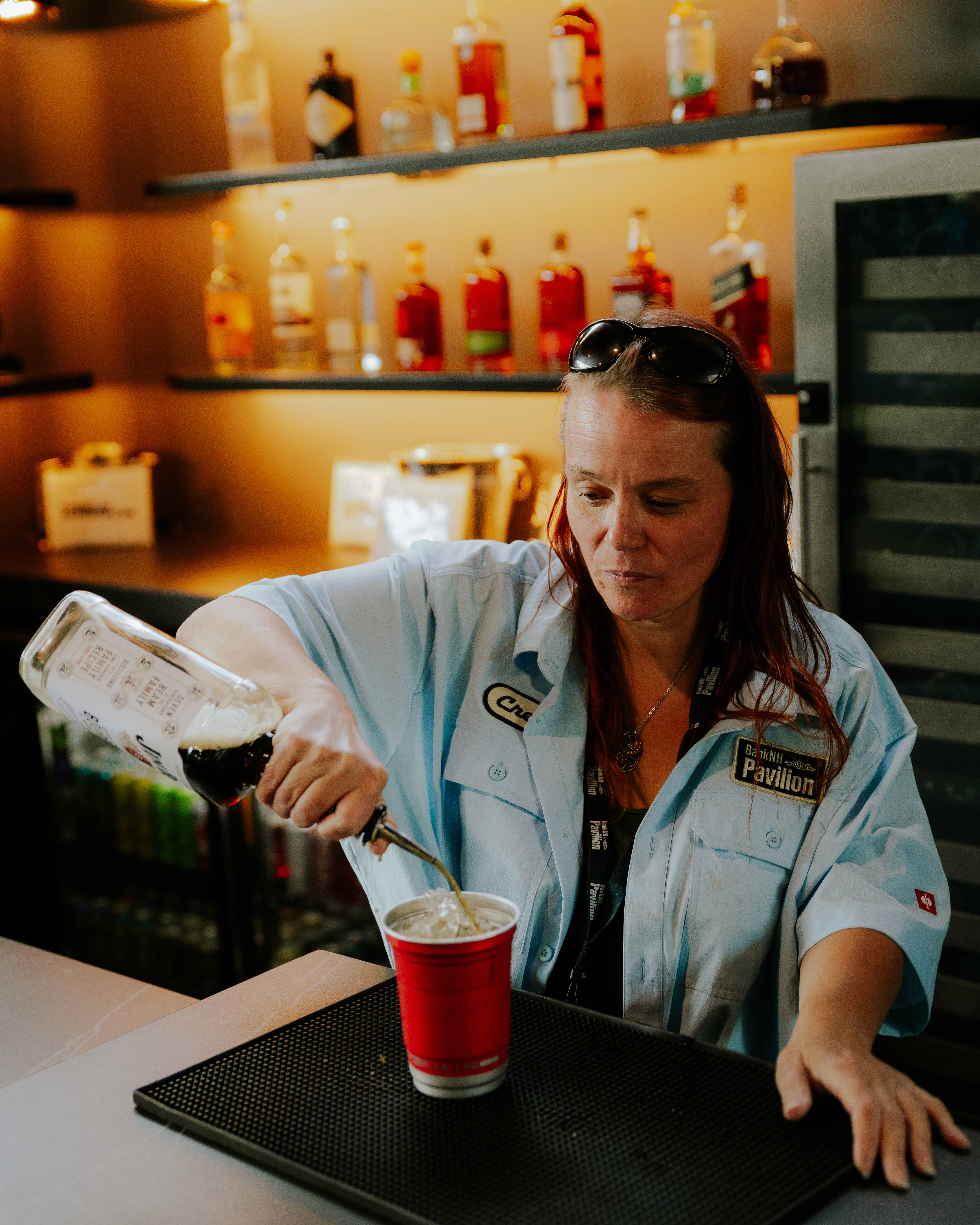 woman pouring a drink in a VIP club