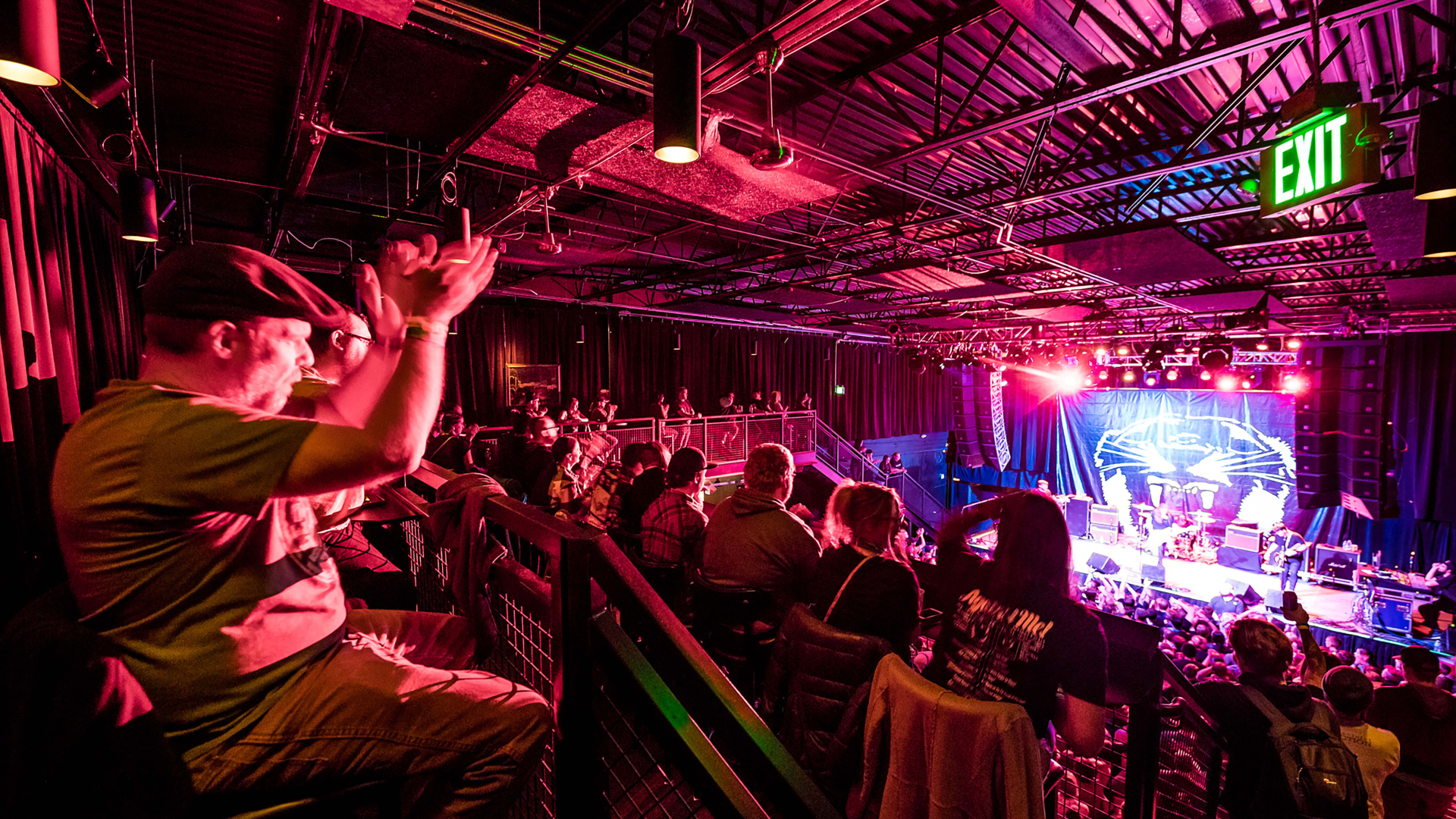 A fan watching the show at Summit from the balcony.