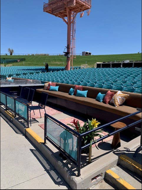 This is a photo of the Premium Seating Area, showing a couch with pillows and chairs.