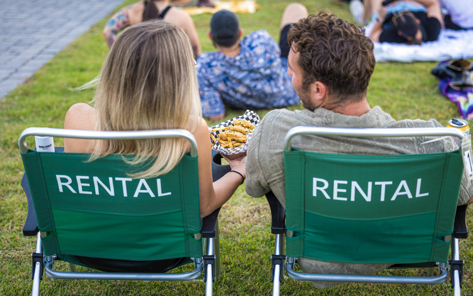 A couple sitting in lawn chairs at the show.