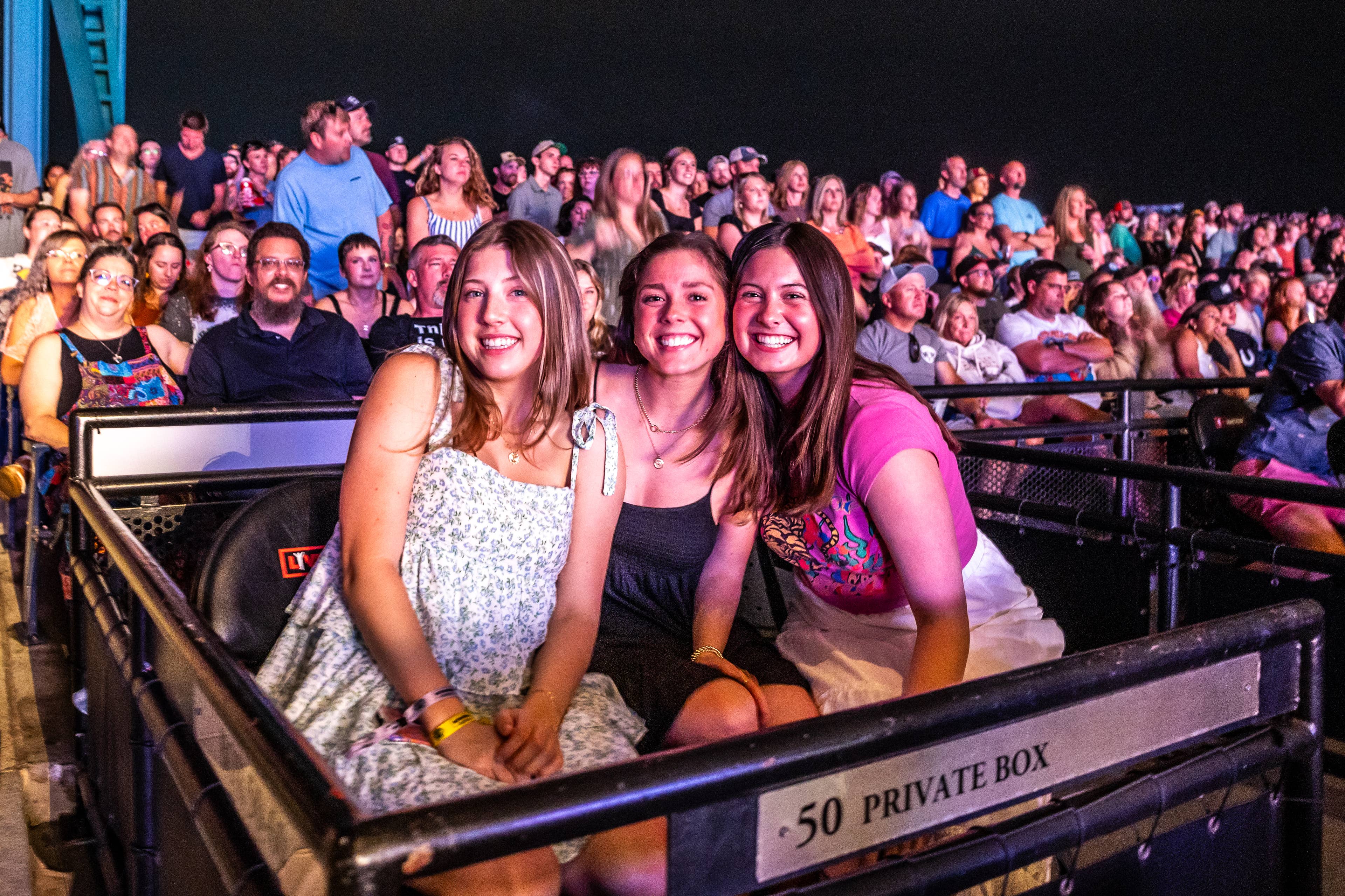 A photo of three girls smiling in our private box seats
