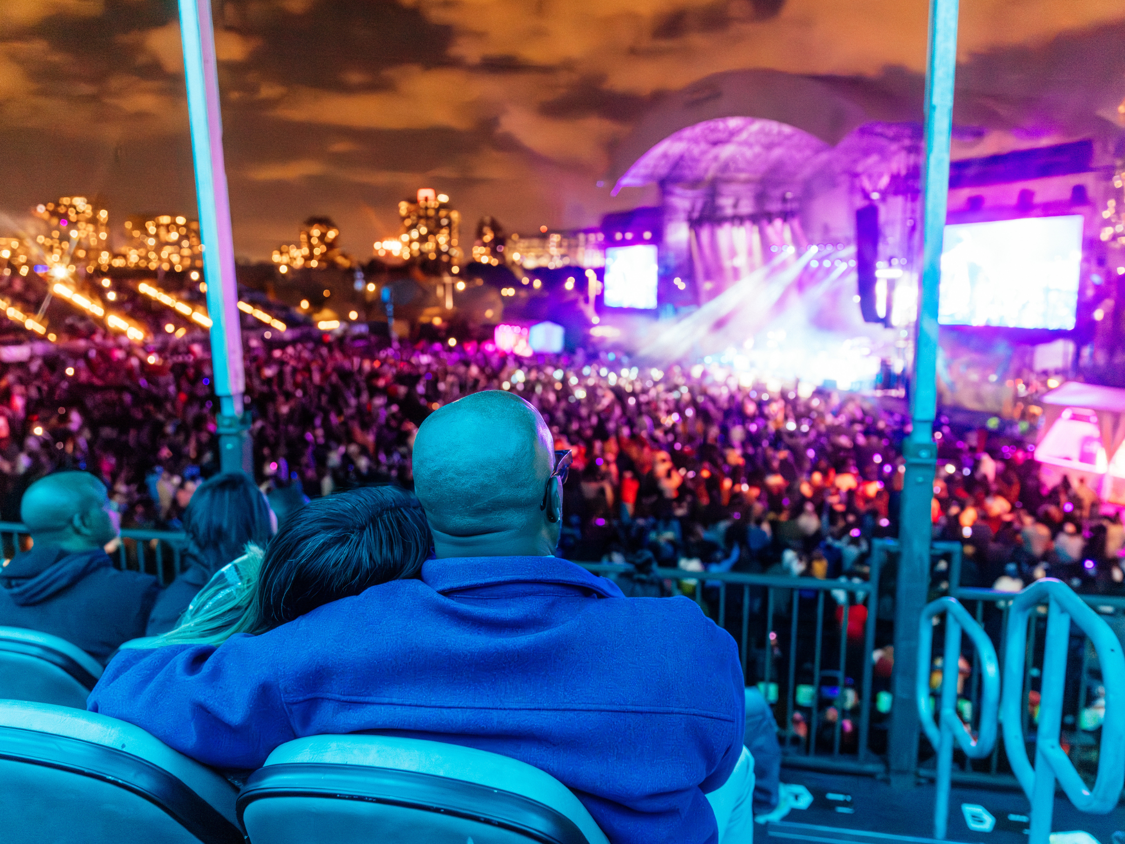Two people sitting in box seats watching the show.