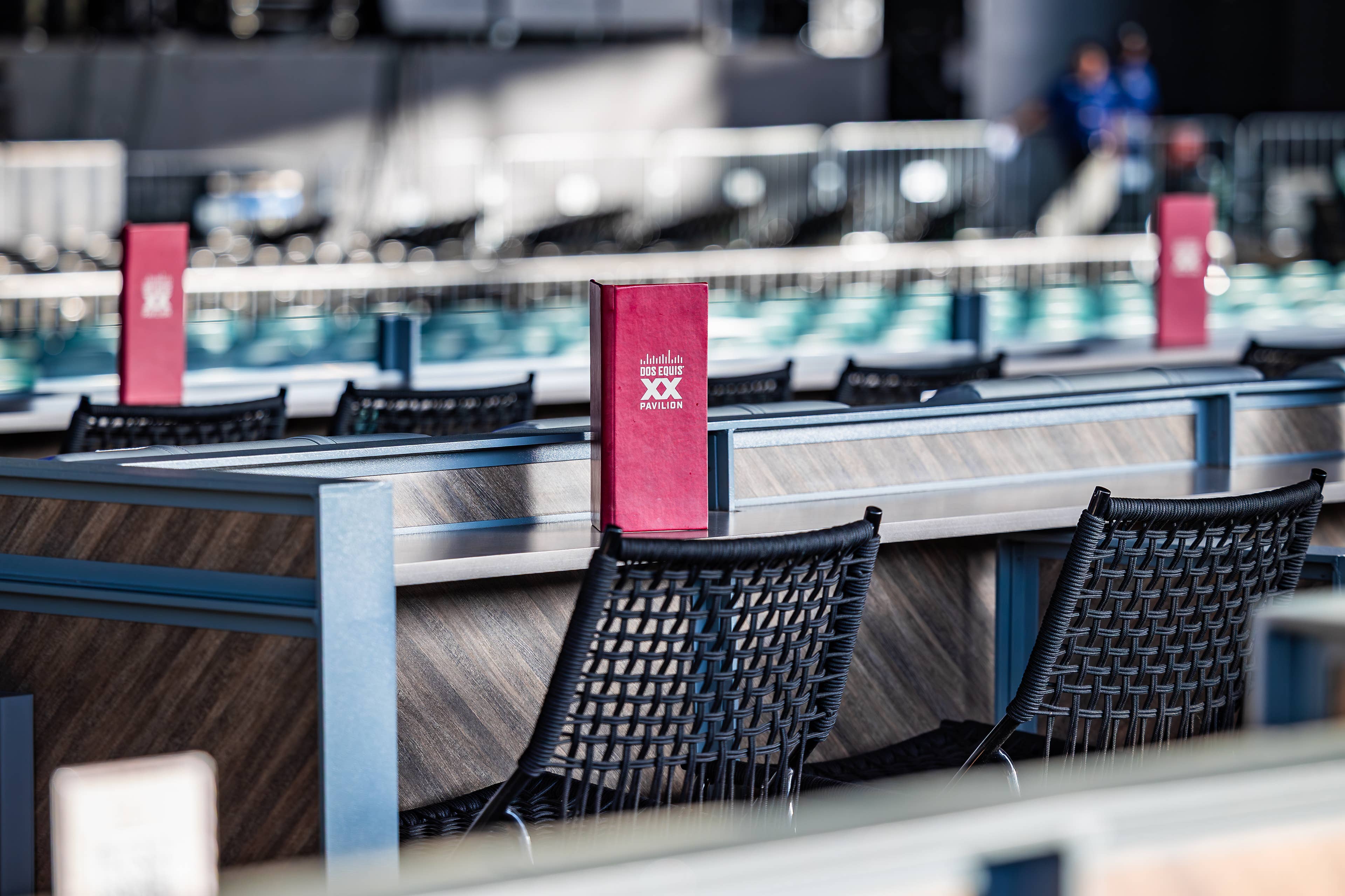 Photo shows a menu on a table of the Premium Seating area with black chairs next to each other.
Live Nation presents Peso Pluma at Dos Equis Pavilion in Dallas, Texas on April 10, 2026. (Photo by ALIVE for Live Nation)
