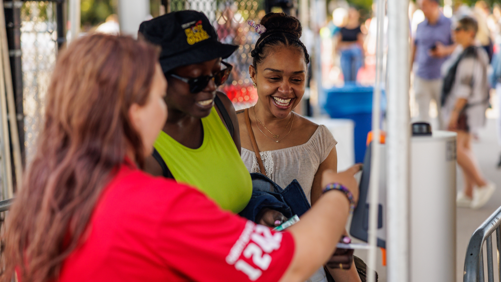 An attendant helping attendees scan their ticket