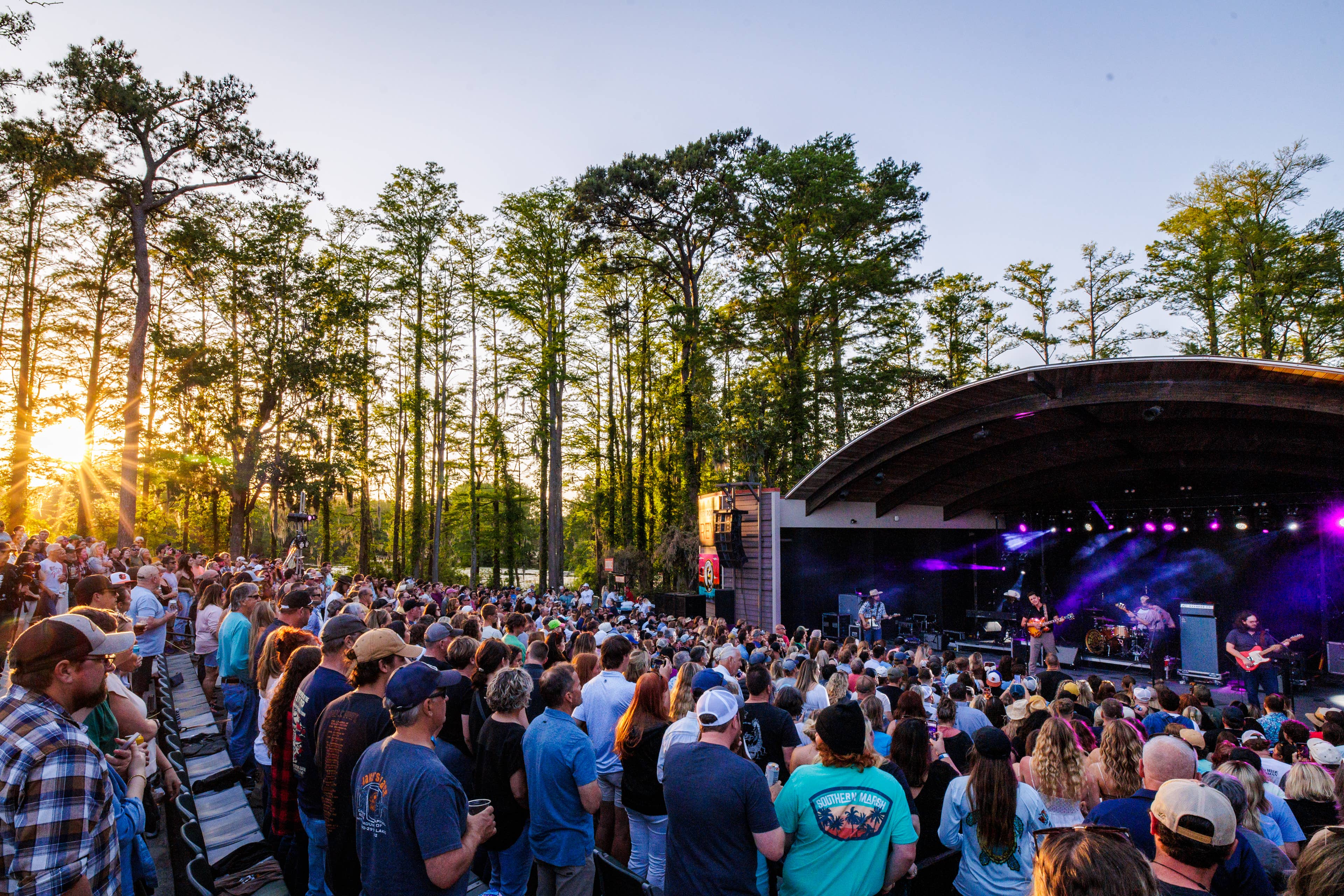 An image of the crowd watching a show during sunset at the venue.