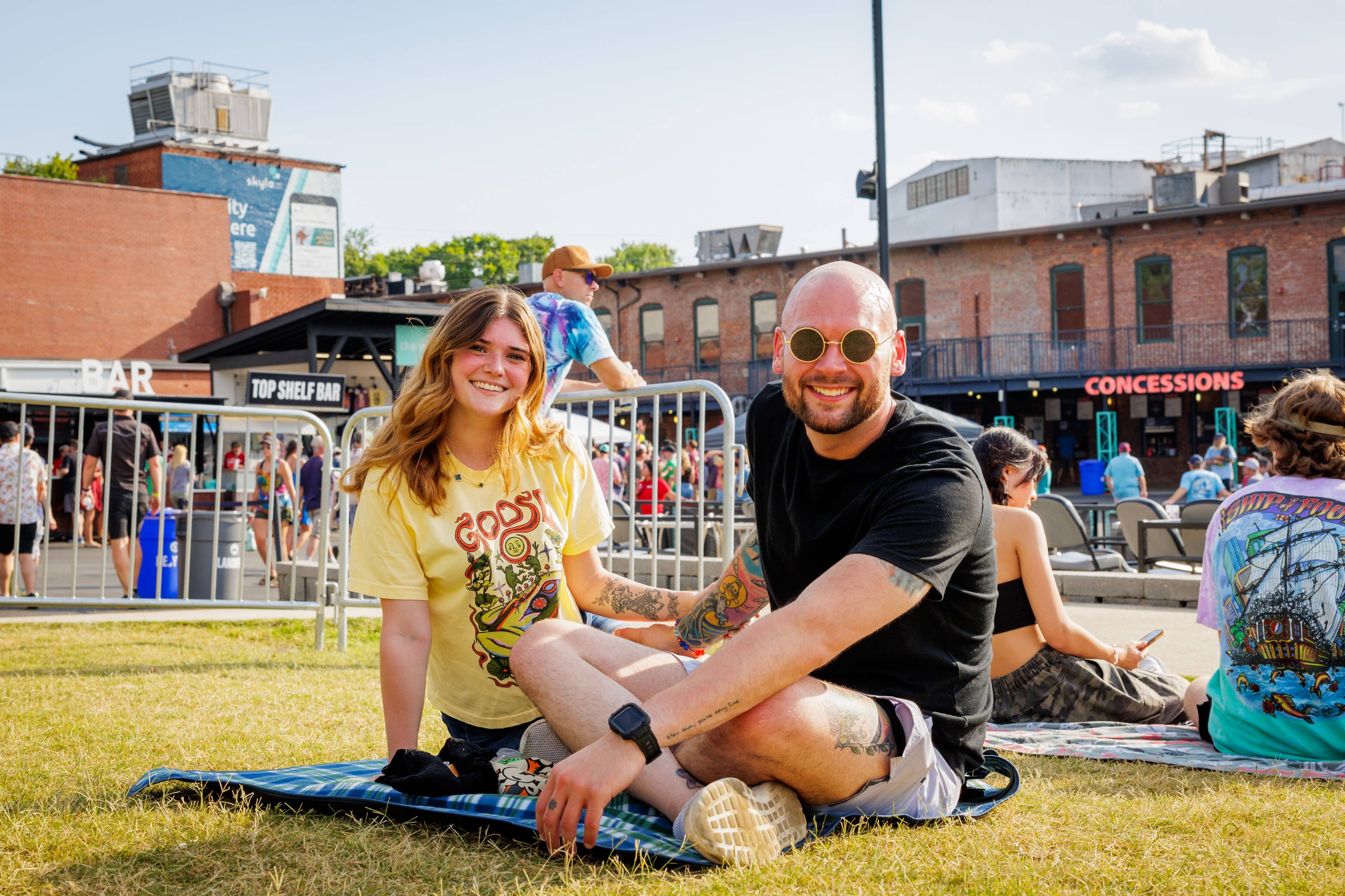 Fans sitting on a blanket on the lawn at Skyla Credit Union Amphitheatre.
