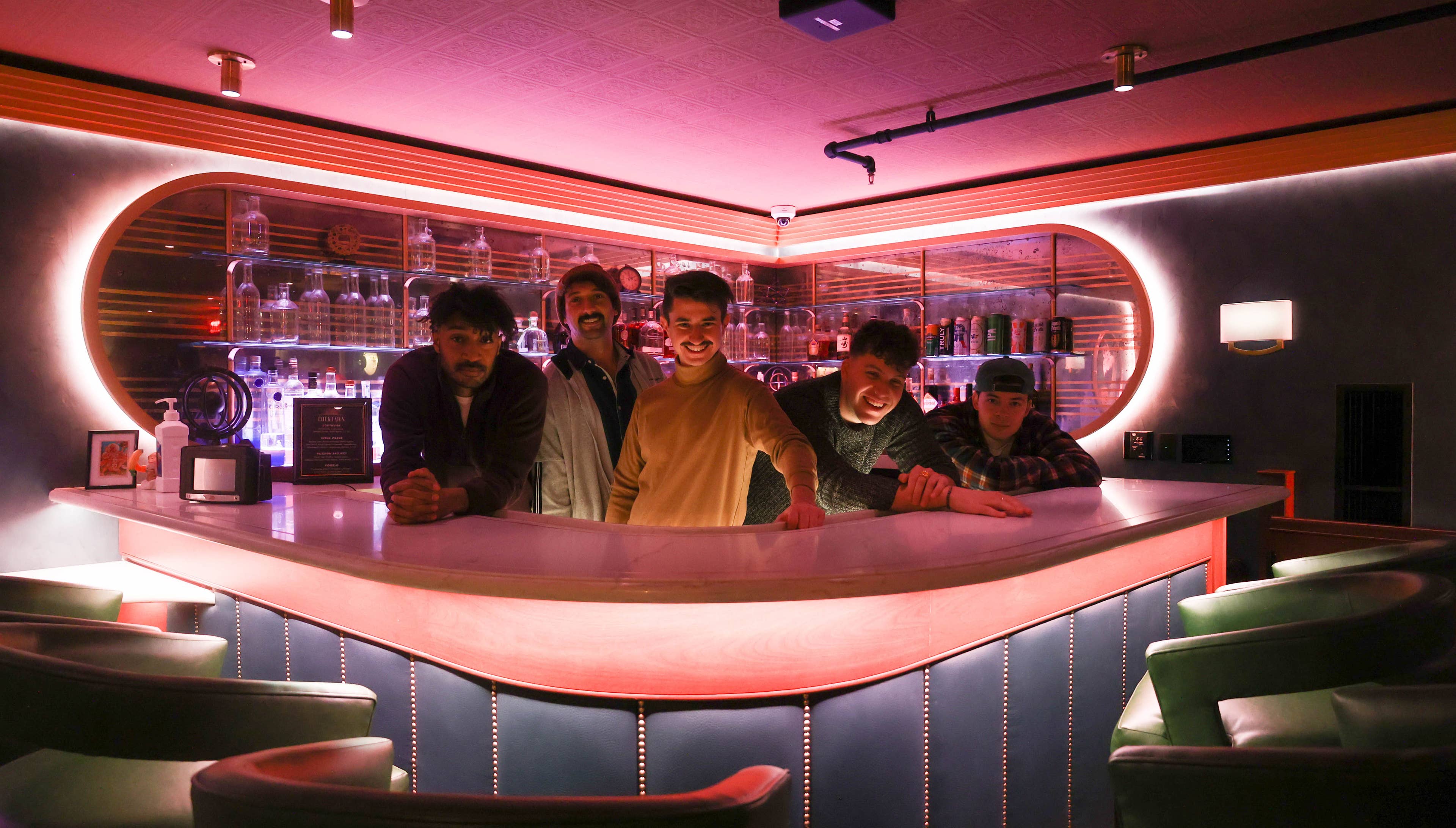 Members of the band Juice behind a bar.