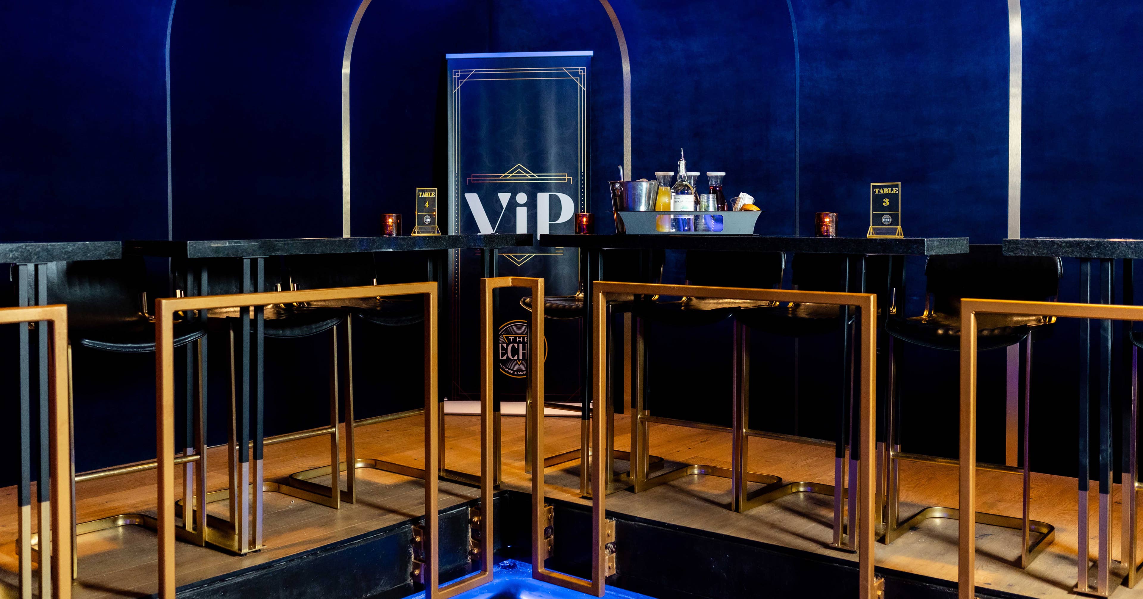 Image of VIP section with high top tables and bar stools